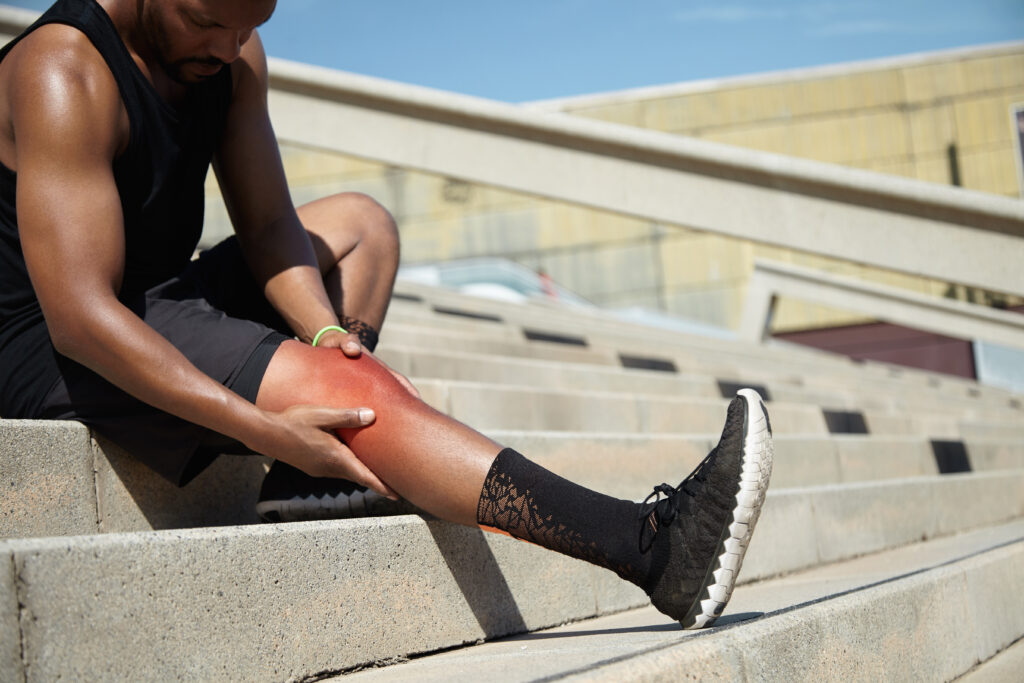 closeup young man with knee injury